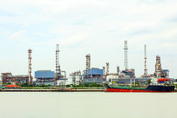 Oil refinery petroleum factory with tanker ship.