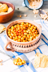 baked chickpeas with spices on rustic background, smoked paprika