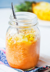 smoothie with tropical fruits, pineapple, peach and green buckwh
