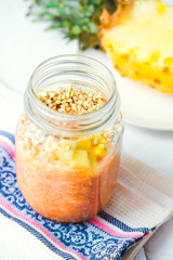 smoothie with tropical fruits, pineapple, peach and green buckwh