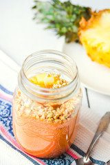 smoothie with tropical fruits, pineapple, peach and green buckwh