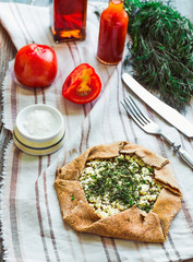 baked crispy rye biscuit with goat cheese and herbs, fresh tomat