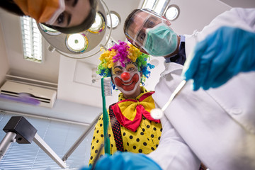 Clown with dentist in bottom view