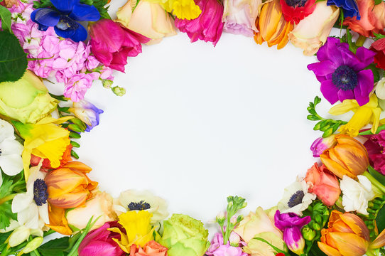 Flowers frame in white background isolated. Frame: different colorful flowers on the white background. Beautiful spring background with free space for text.