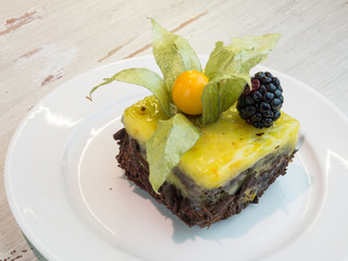 Citrus cake with chocolate and blackberries.