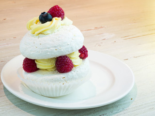 Meringues with raspberries and cream.