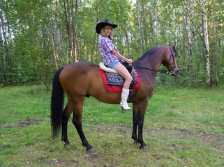 Young woman riding on  horse