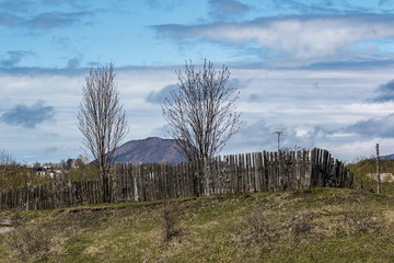 Fototapeta premium wooden fence in countryside and mountain in the background