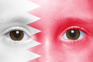 human's face with bahrain flag