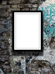 Close-up of one black picture frame on graffiti wall background