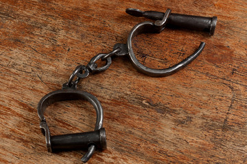 vintage metal handcuffs on the wooden table