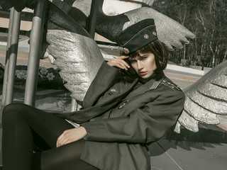 beautiful girl in military uniform with military equipment