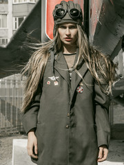beautiful girl in military uniform with military equipment