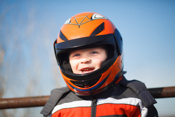 A boy in a motorcycle helmet
