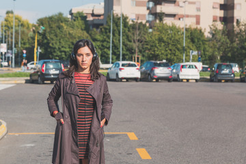 Fototapeta premium Beautiful girl listening to music in an urban context