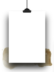 Close-up of one hanged paper sheet frame with clip on brown watercolour stain background