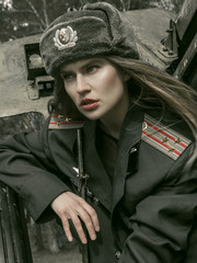 beautiful girl in military uniform with military equipment