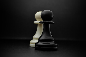 Chess. Black and White pawns on the black background. Pawns, infantry chess.