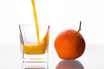 Orange juice pouring into glass