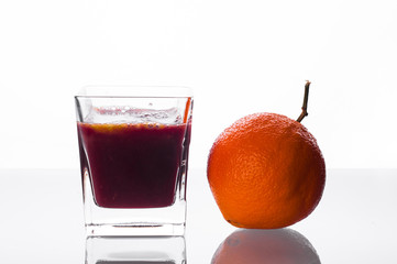 blackcurrant juice pouring into glass with orange juice