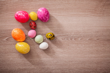 Obraz na płótnie Canvas Close up of colorful Easter eggs on wooden background