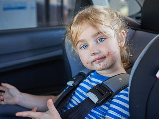 Little dirty girl , baby in a safety car seat. - 103244123