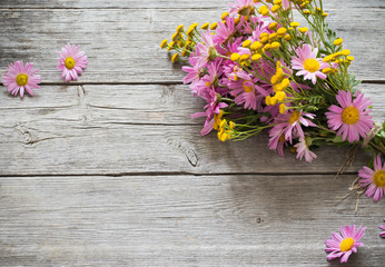 bouquet of pink and yellow flowers on wooden background