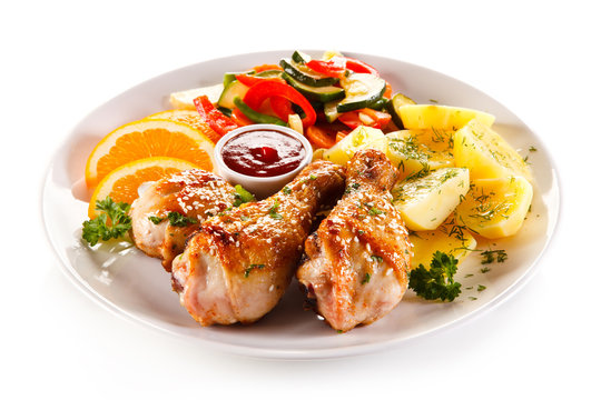 Grilled chicken legs with boiled potatoes and vegetables