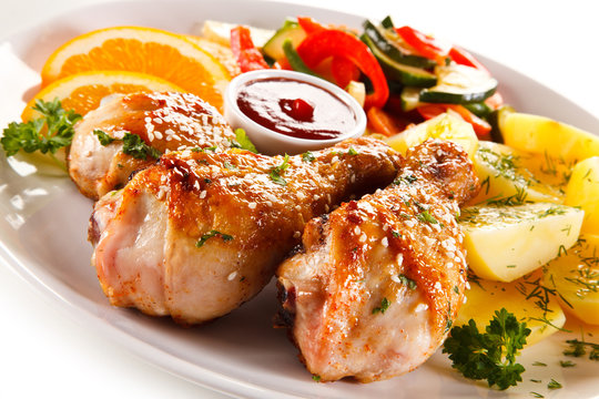 Grilled chicken legs with boiled potatoes and vegetables
