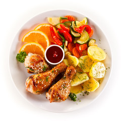 Grilled chicken legs with boiled potatoes and vegetables