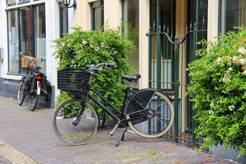 Parked bicycles near the old houses on the narrow street