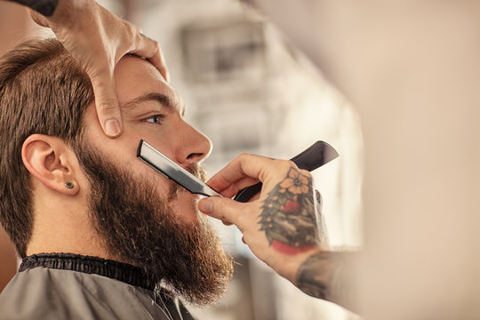 Barber With Old-fashioned Black Razor.