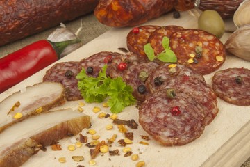 
Spicy sausages on a wooden cutting board. Preparing the menu. Entertainment for visitors. Production of delicious sausages.
