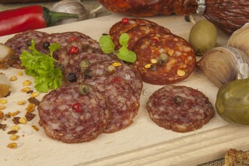 
Spicy sausages on a wooden cutting board. Preparing the menu. Entertainment for visitors. Production of delicious sausages.
