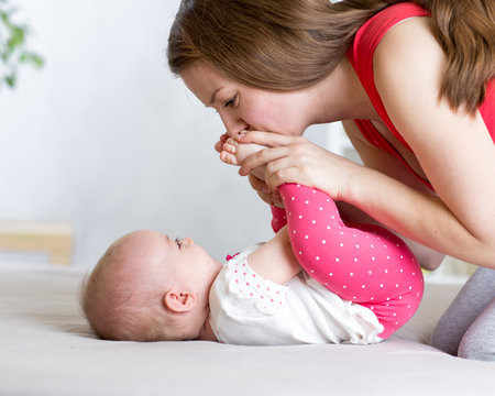 Joyful Mom Playing With Her Baby Infant