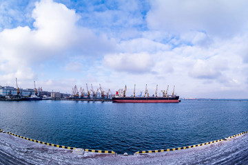 Cargo ship in the port in winter