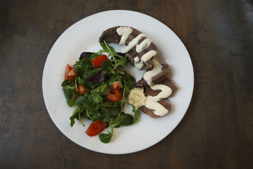 Pork tongue with a green salad and horseradish.