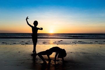Kids posing at the beach during sunset