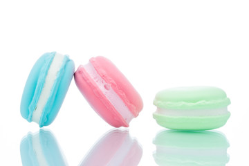 French colorful macarons stacks on white background