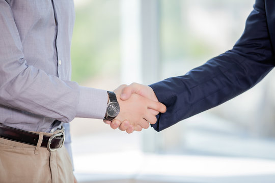 close-up of handshake of two businessmen in business suits