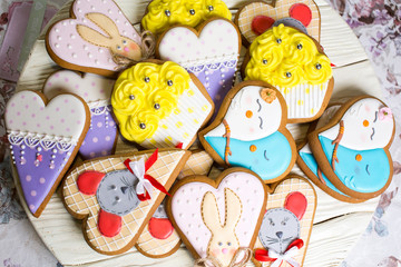 a collection of gingerbread cookies in the shape of a heart, muffins and animals on a white wooden background