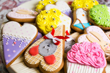 a collection of gingerbread cookies in the shape of a heart, muffins and animals on a white wooden background