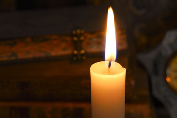 candle flame and antique books