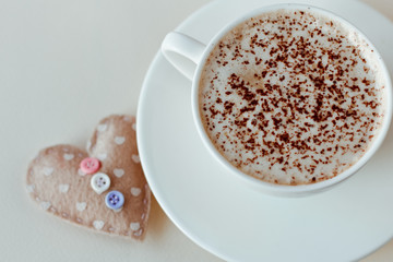 Beautiful coffee Cup with heart on a white wooden background