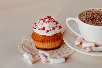 Beautiful coffee Cup with heart cupcake on white wooden background