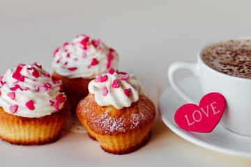 Beautiful coffee Cup with heart cupcake on white wooden background