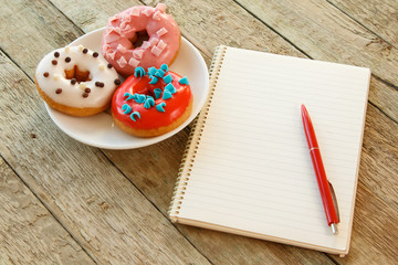 Colorful donuts and notepad