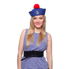 Fototapeta premium Young blond female sailor posing in her uniform and looking at the camera isolated on white background