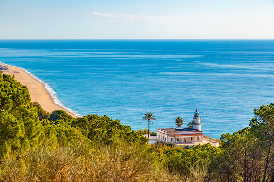 The famous lighthouse near Calella, Spain, overlooking the blue Mediterranean Sea.