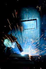 Arc welder wearing protective clothes at work